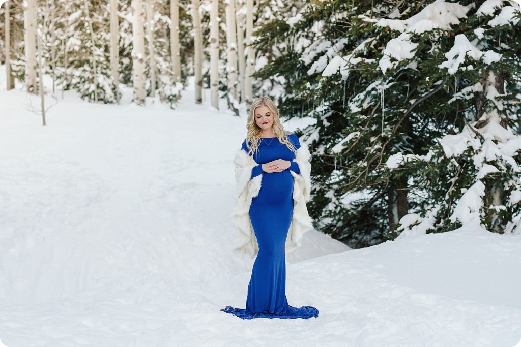 royal blue maternity gown in snowy mountains for maternity session with Beka Price Photography