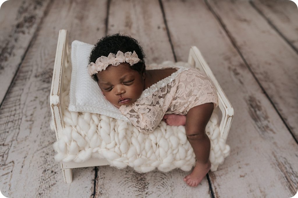baby girl sleeps on tiny bed during elegant newborn session with Beka Price Photography