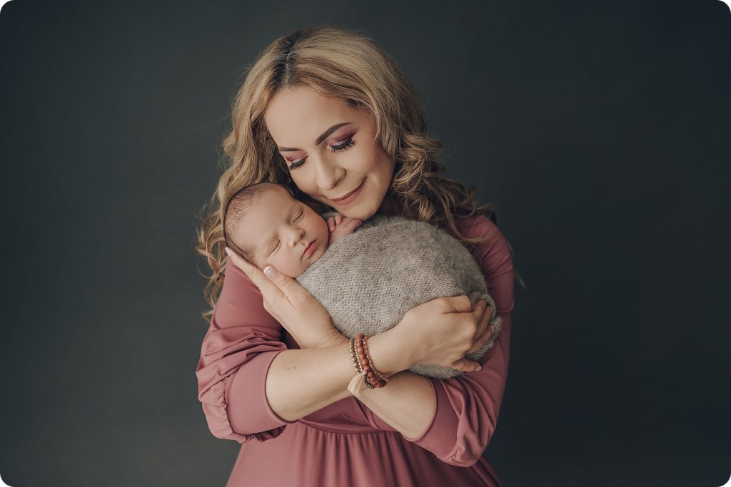 mom in pink shirt holds baby boy photographed by Beka Price Photography