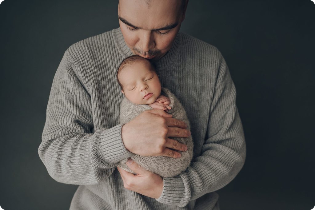 dad holds baby boy during portraits with Beka Price Photography