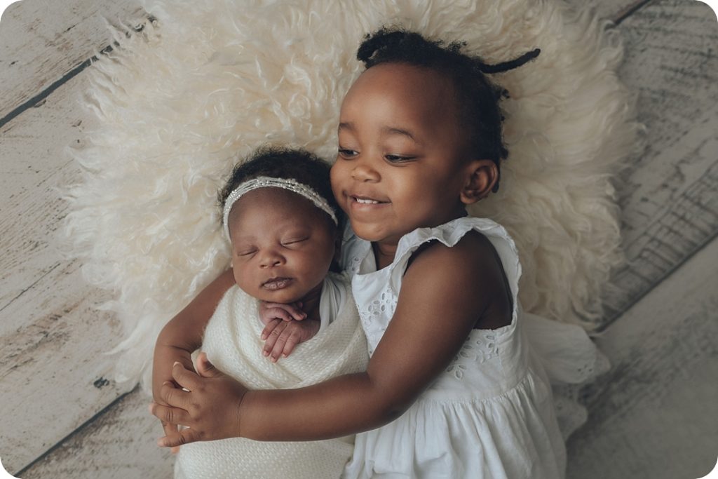Beka Price Photography photographs siblings during newborn portraits