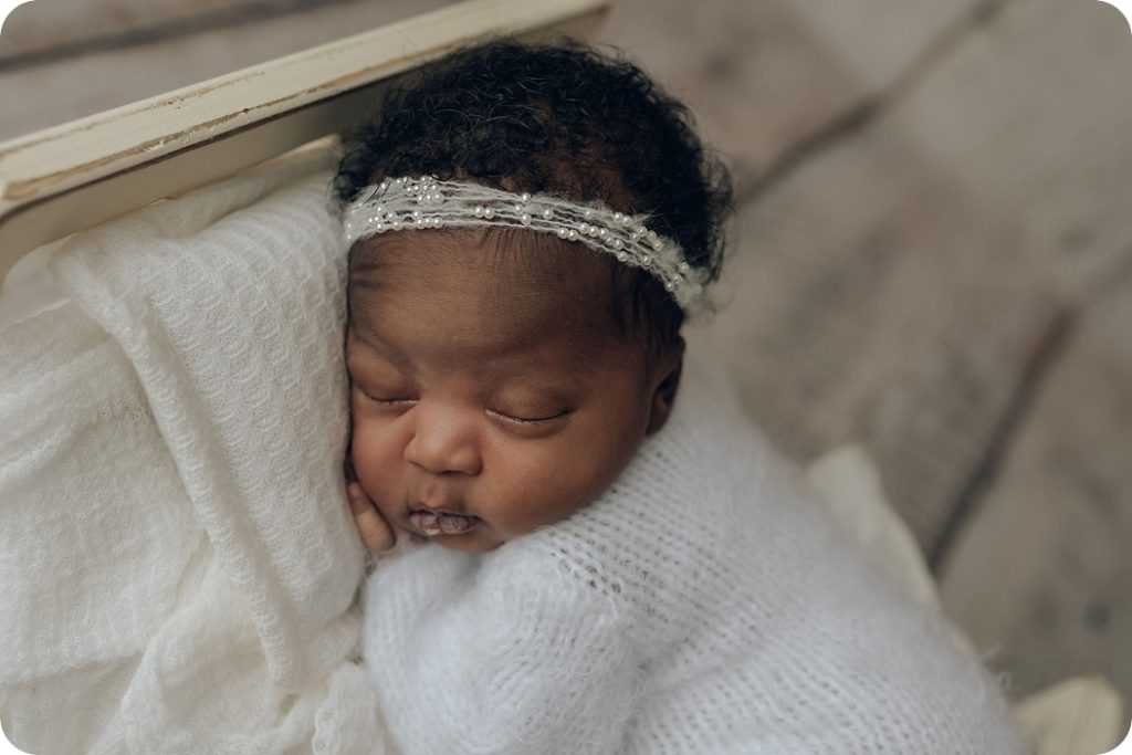 Beka Price Photography captures baby girl sleeping on pillow during newborn portraits