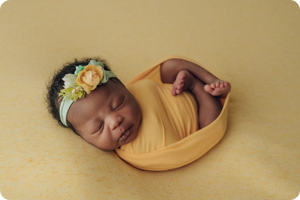 baby girl wrapped in yellow wrap with headband photographed by Beka Price Photography