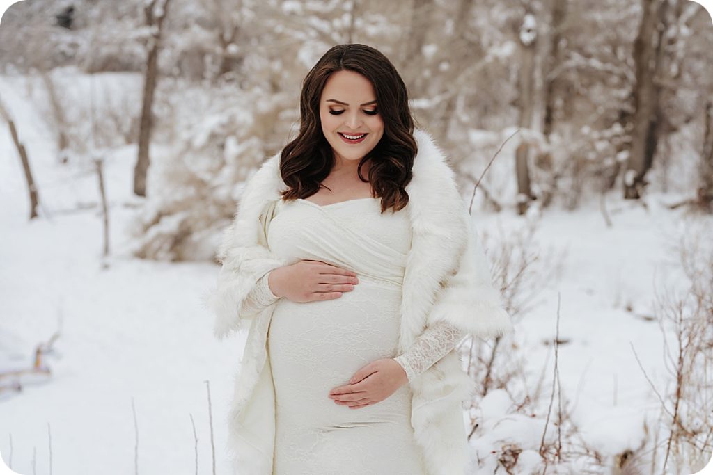 Beka Price Photography photographs mom in white out snow maternity portraits