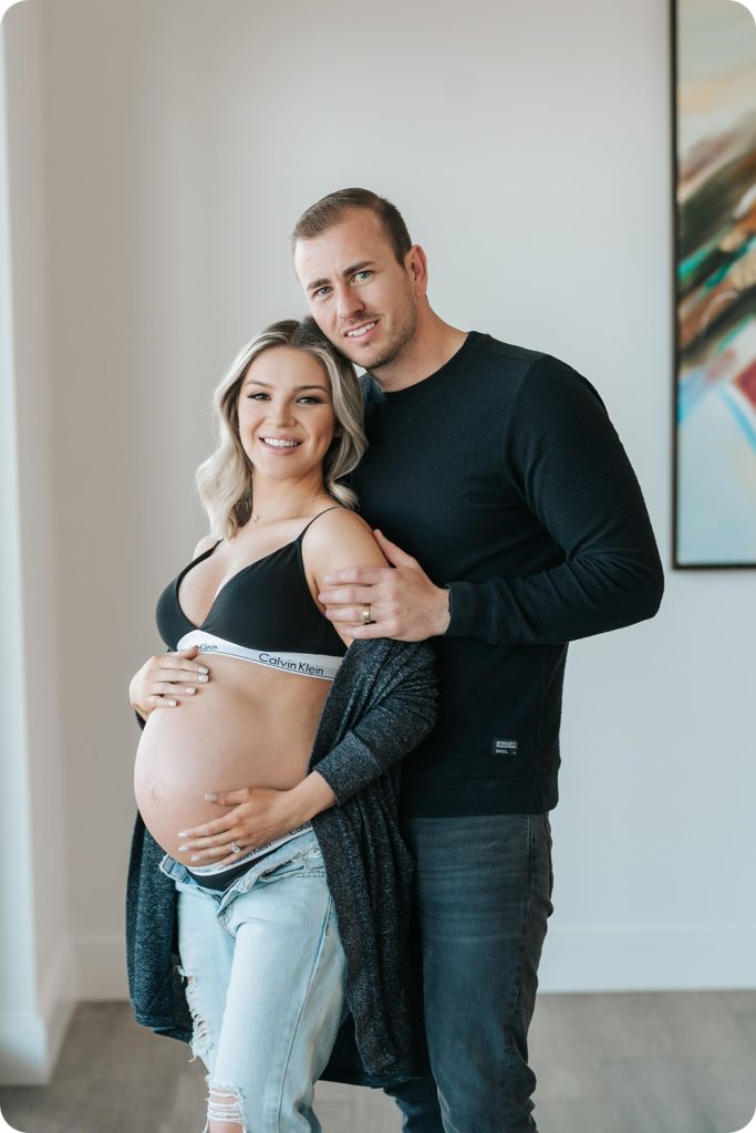 expecting couple poses in Utah home for maternity portraits