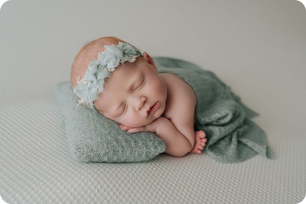 little girl sleeps during classic newborn portraits in Utah
