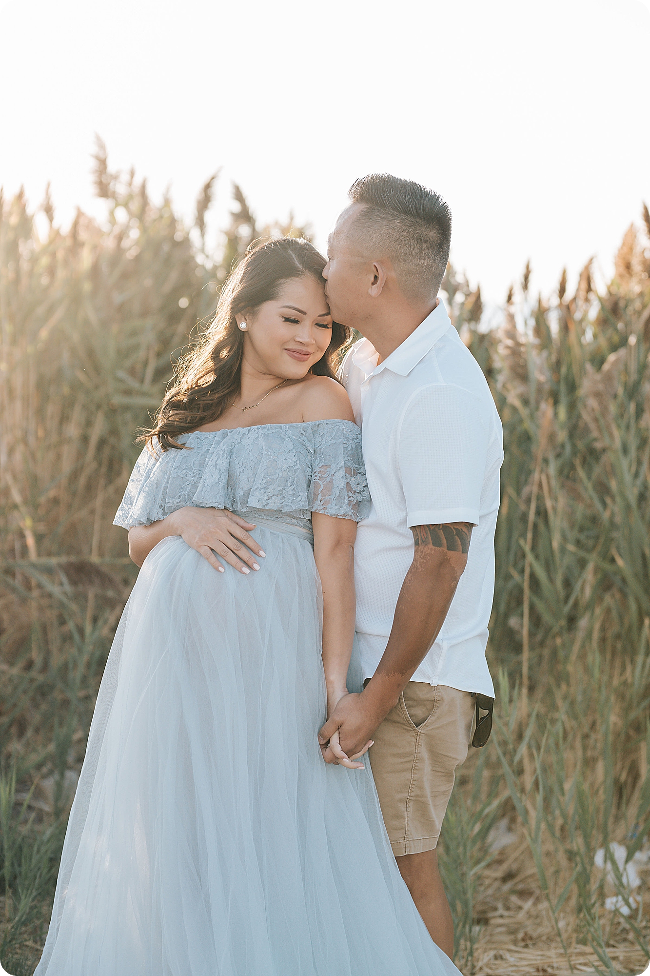 husband kisses wife's forehead during UT maternity session