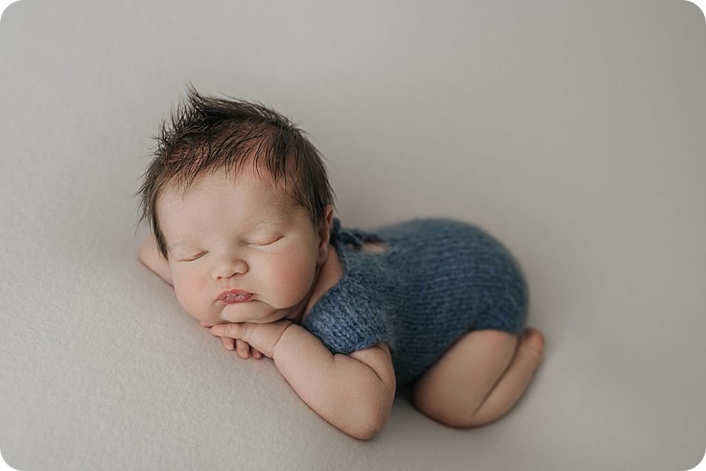Utah newborn sleeps in blue wrap