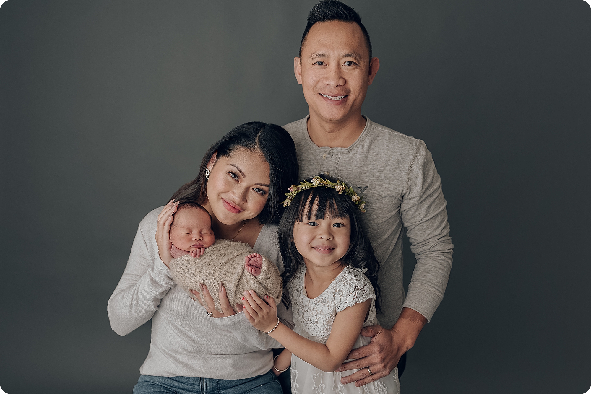 family poses with newborn baby boy in studio with Beka Price Photography