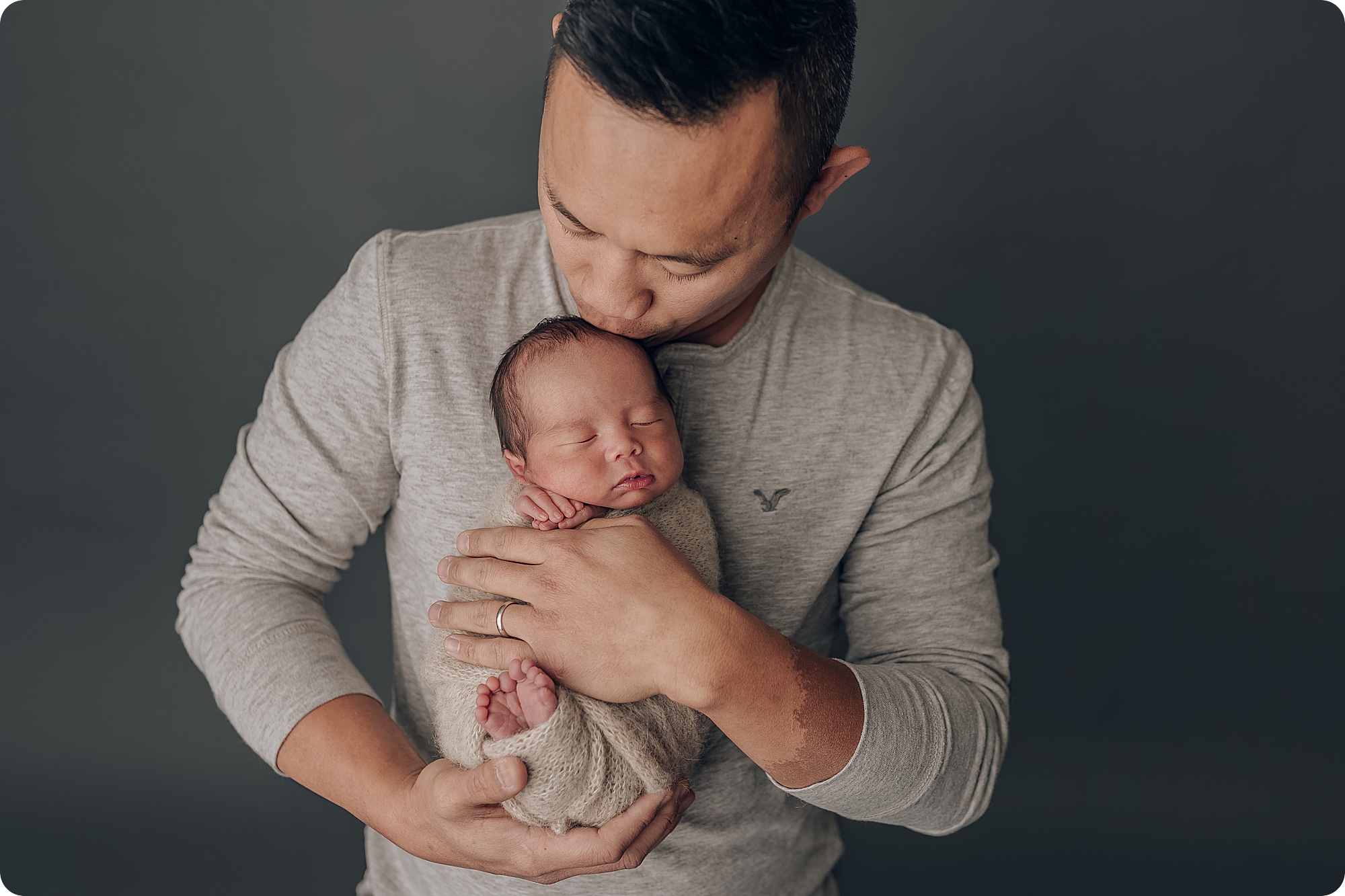 dad kisses newborn baby boy during classic studio newborn session with Beka Price Photography
