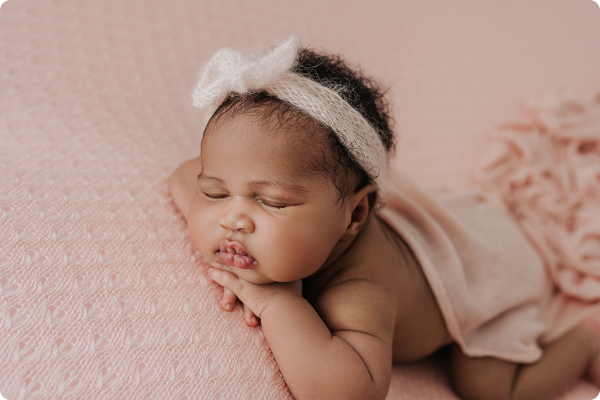 baby girl sleeps on hand during Utah newborn session with Beka Price Photography