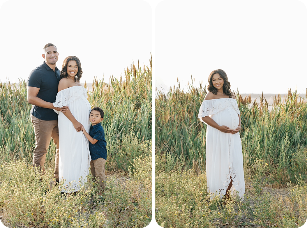 mom poses in grass at Utah lake in lace maternity gown