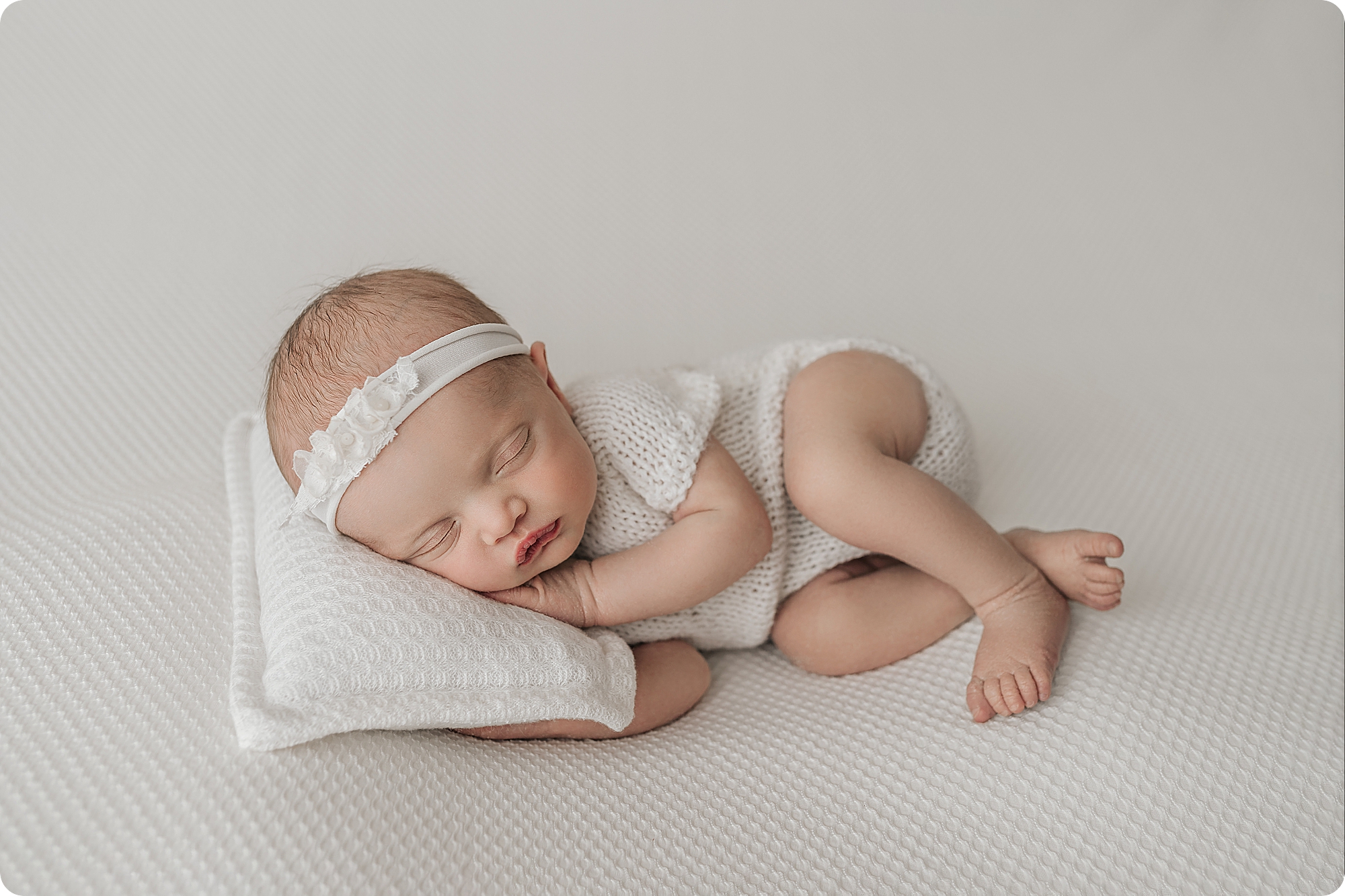 baby sleeps on pillow during cozy studio newborn portraits in Utah studio with Beka Price Photography