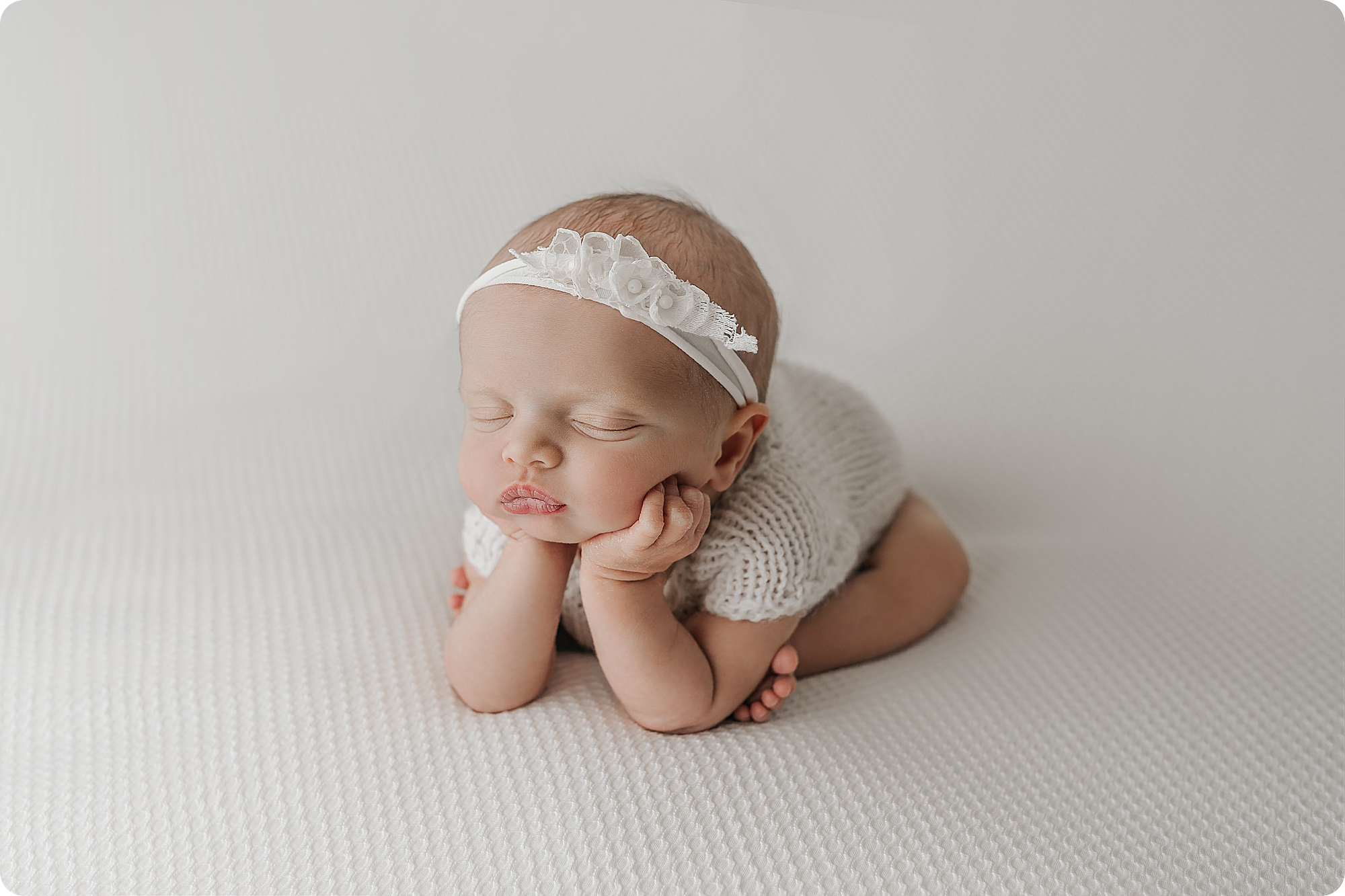 baby girl in froggy pose during cozy studio newborn portraits in Utah studio