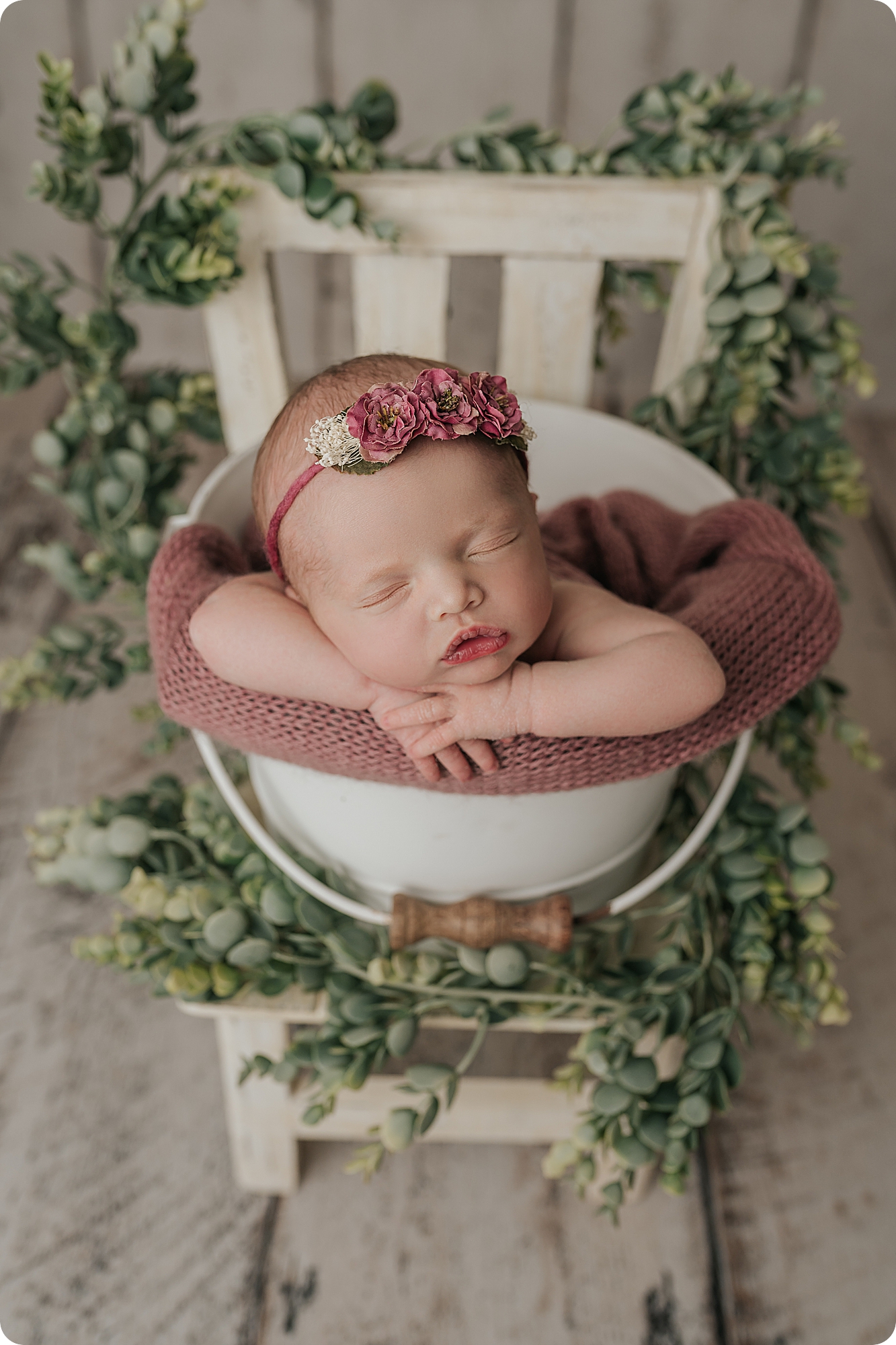baby girl sleeps in basket during cozy studio newborn portraits in Utah studio