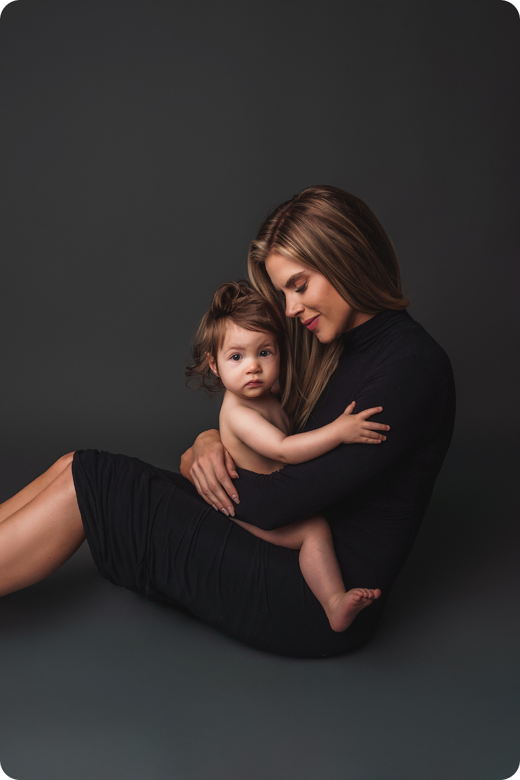 mom holds baby girl during Utah studio motherhood session