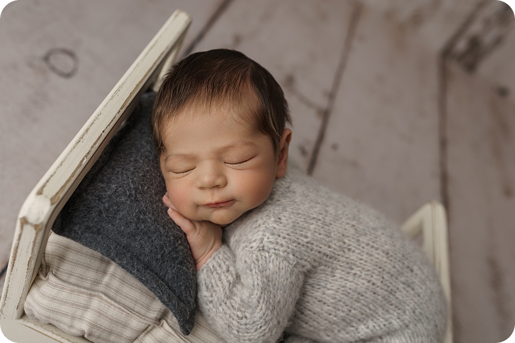 baby sleeps on wool pillow during newborn photos in Holladay UT