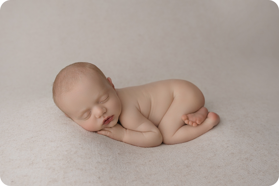naked baby sleeps in Utah studio during newborn portraits 