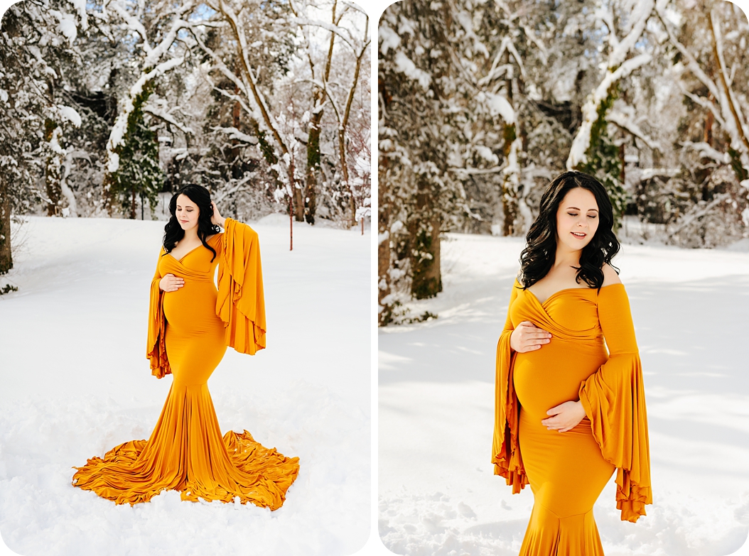 mother in mustard yellow gown poses during winter maternity portraits in the snow