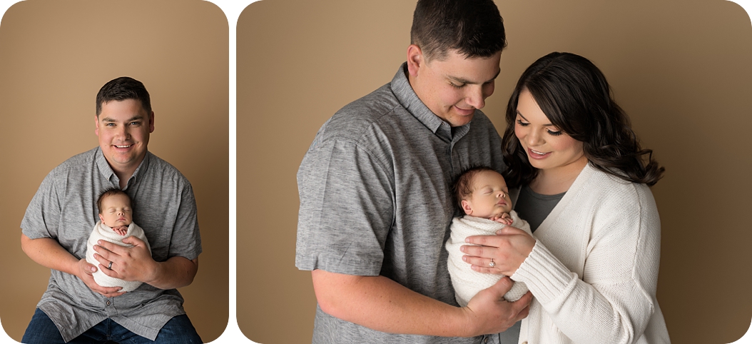 new parents look down at baby boy during UT newborn photos 