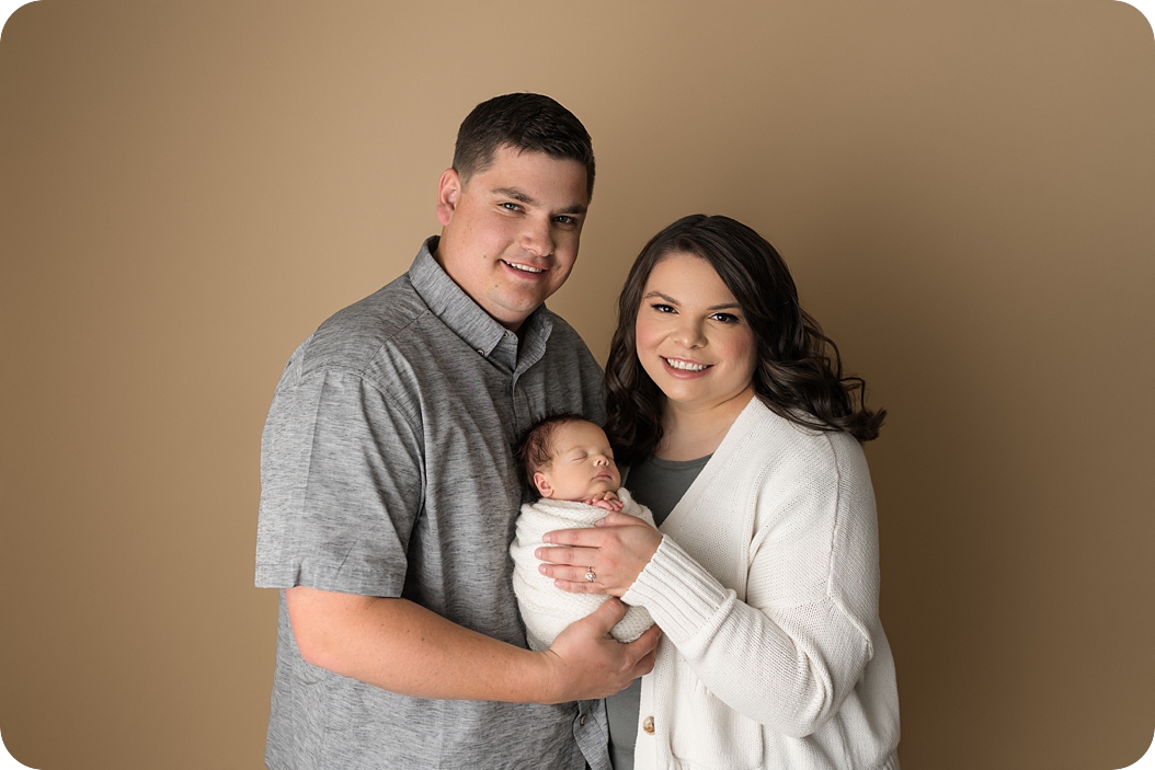 new parents hold baby boy during Utah newborn photos 