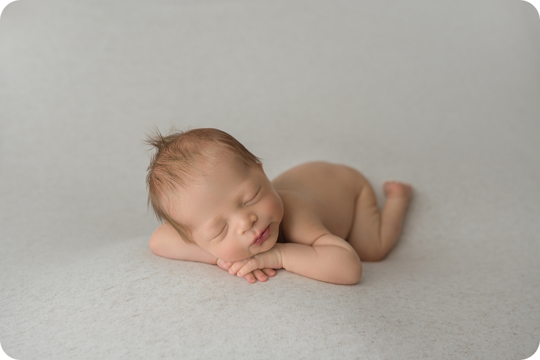 baby boy sleeps during studio newborn photos in Utah studio