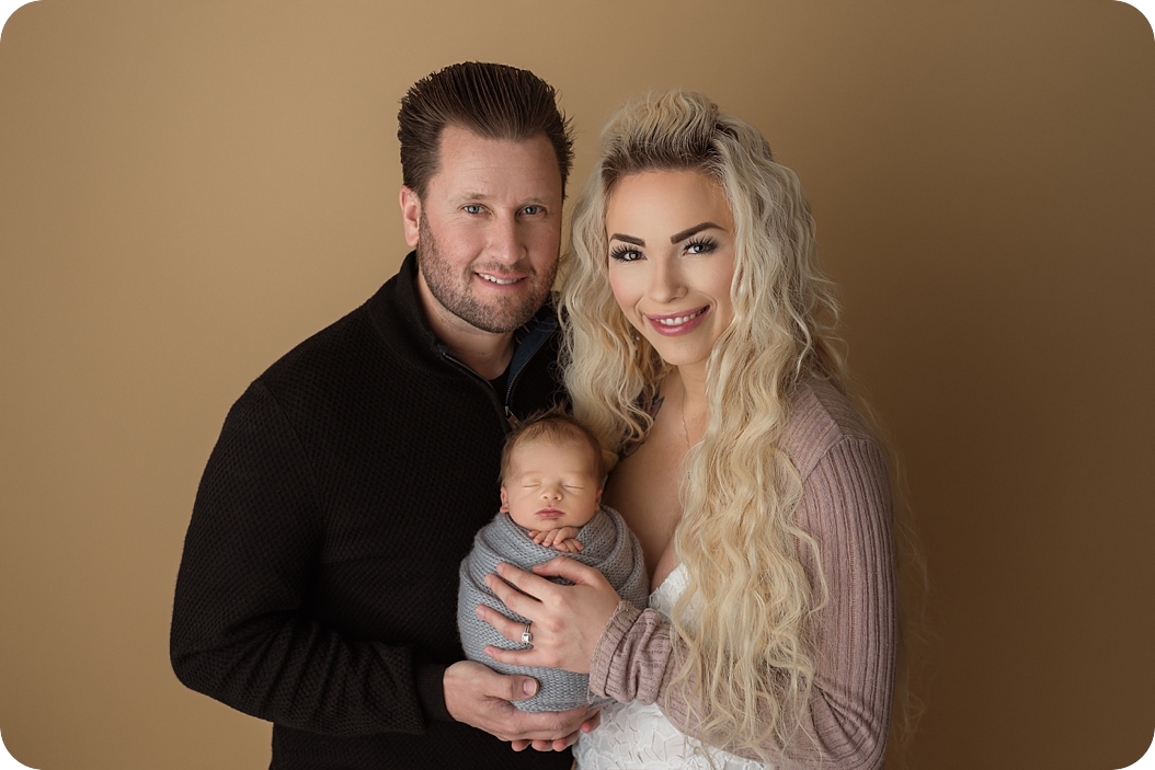 new parents hold baby boy during Studio newborn session in Utah