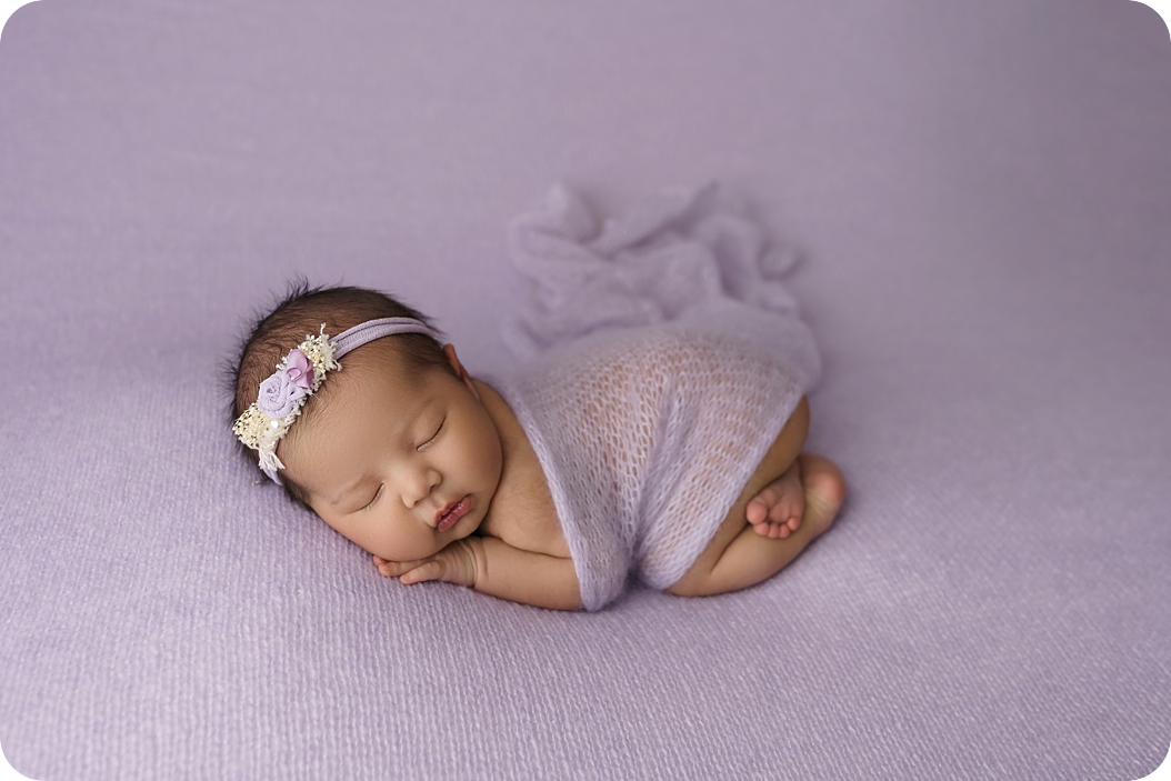 baby sleeps during pastel newborn portraits in Utah studio