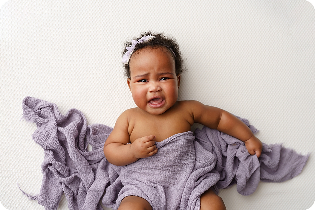 baby girl cries during Studio Milestone Portraits