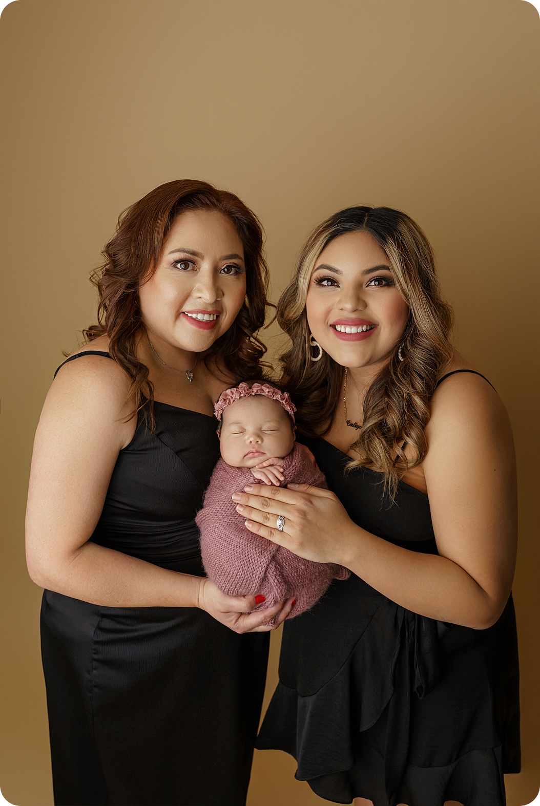 mom and sister hold newborn baby girl