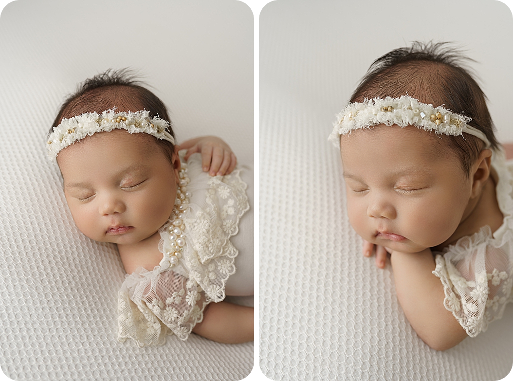 baby sleeps on white setup in white lace outfit 