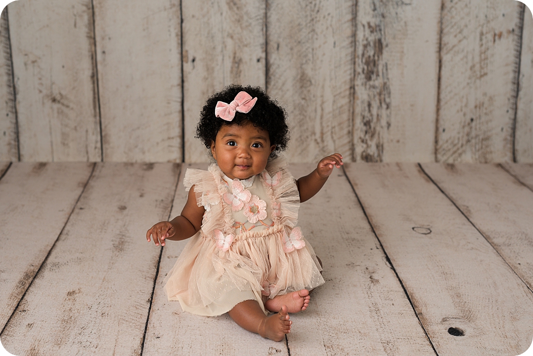 baby girl sits up during classic 8 month milestone portraits