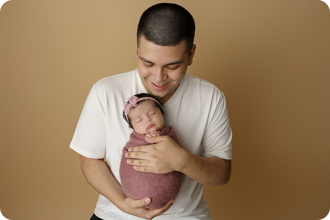 dad holds baby girl during Utah newborn photos 