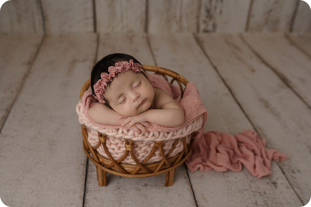 baby in basket sleeps during Utah newborn photos 
