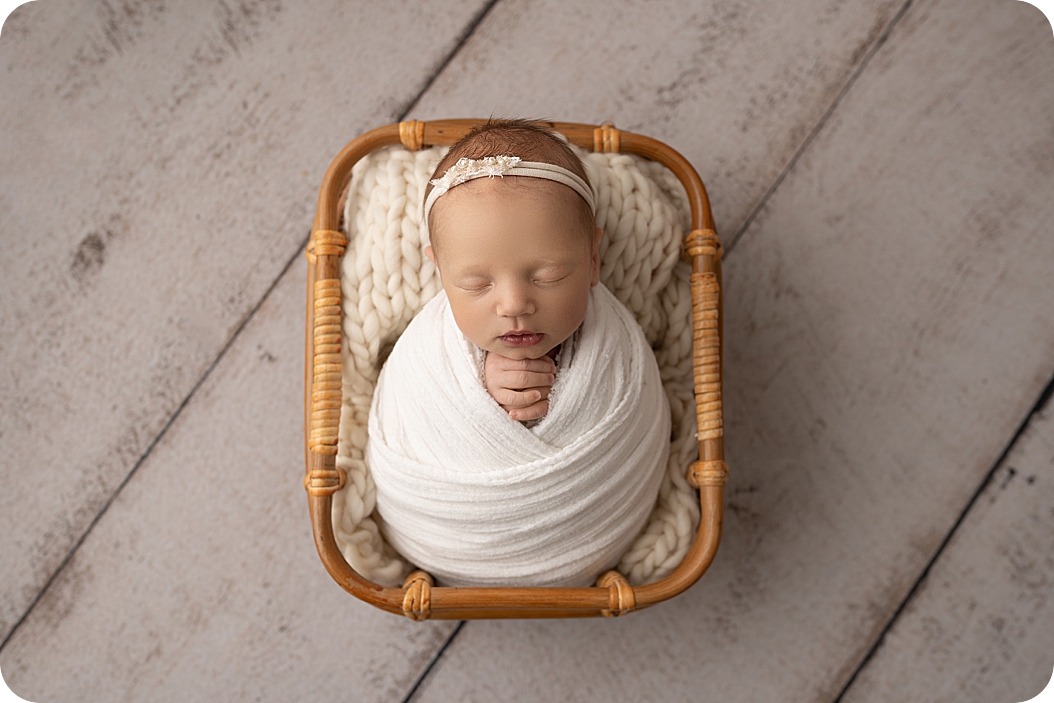 baby sleeps in basket during Studio Newborn Session in Utah 