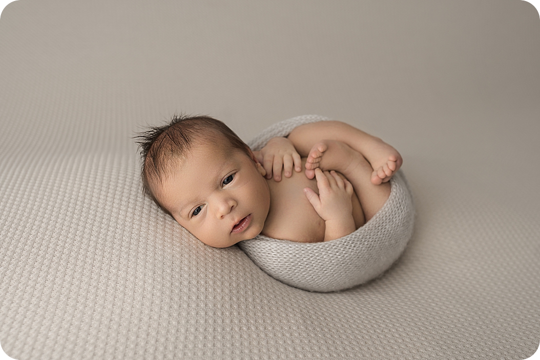 baby sleeps in cream wrap during Utah newborn photos 