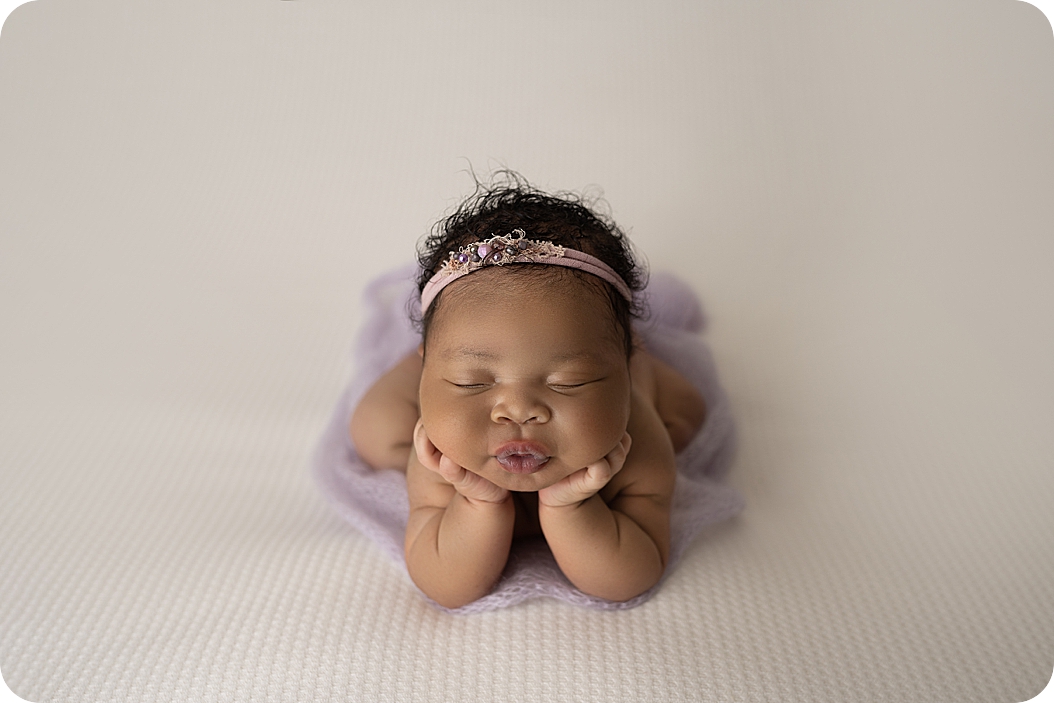 baby in lavender tutu sleeps in froggy pose