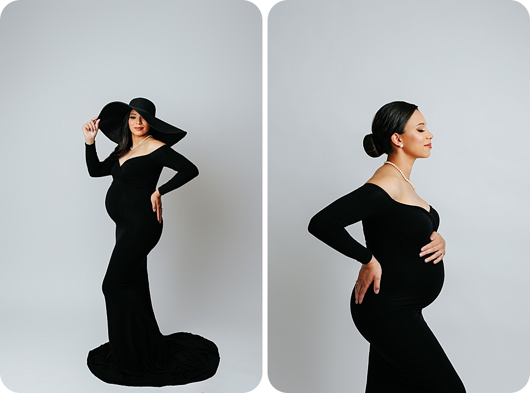 mom holds belly in black dress during maternity photos