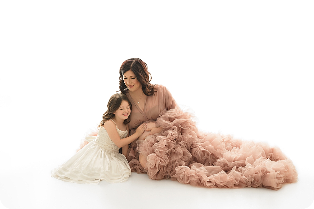 mom and daughter hug during studio maternity session