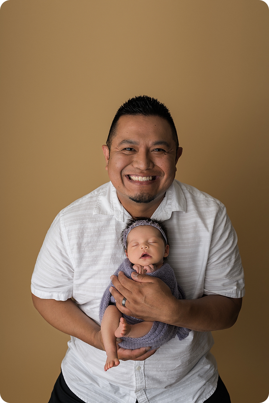 dad holds daughter during Utah Newborn Session