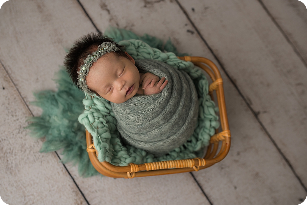 baby in green wrap sleeps during Utah Newborn Session
