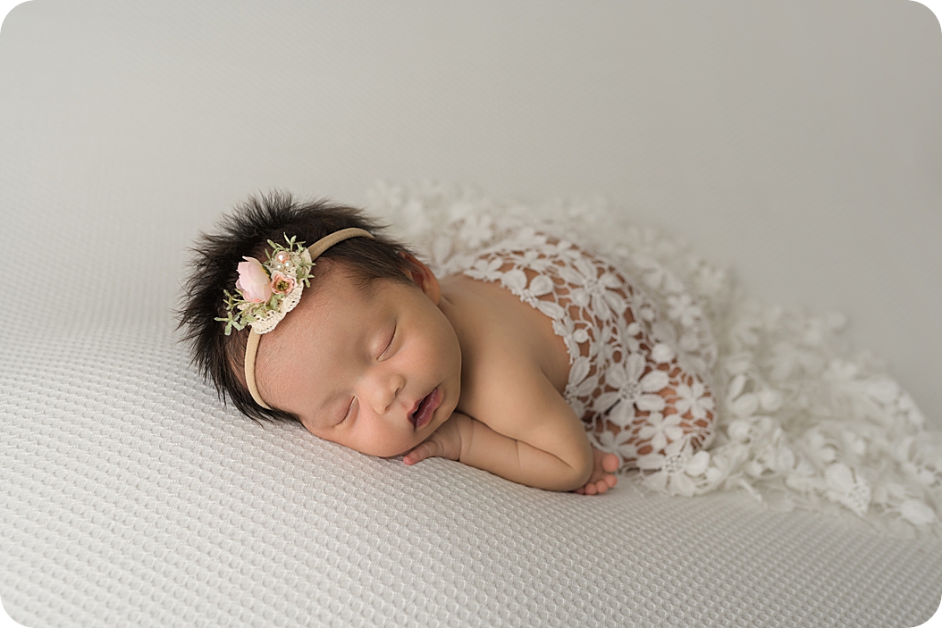 baby sleeps under ivory lace during Utah Newborn Session