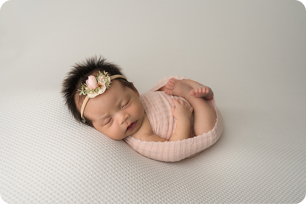 baby in pink wrap sleeps during Utah Newborn Session