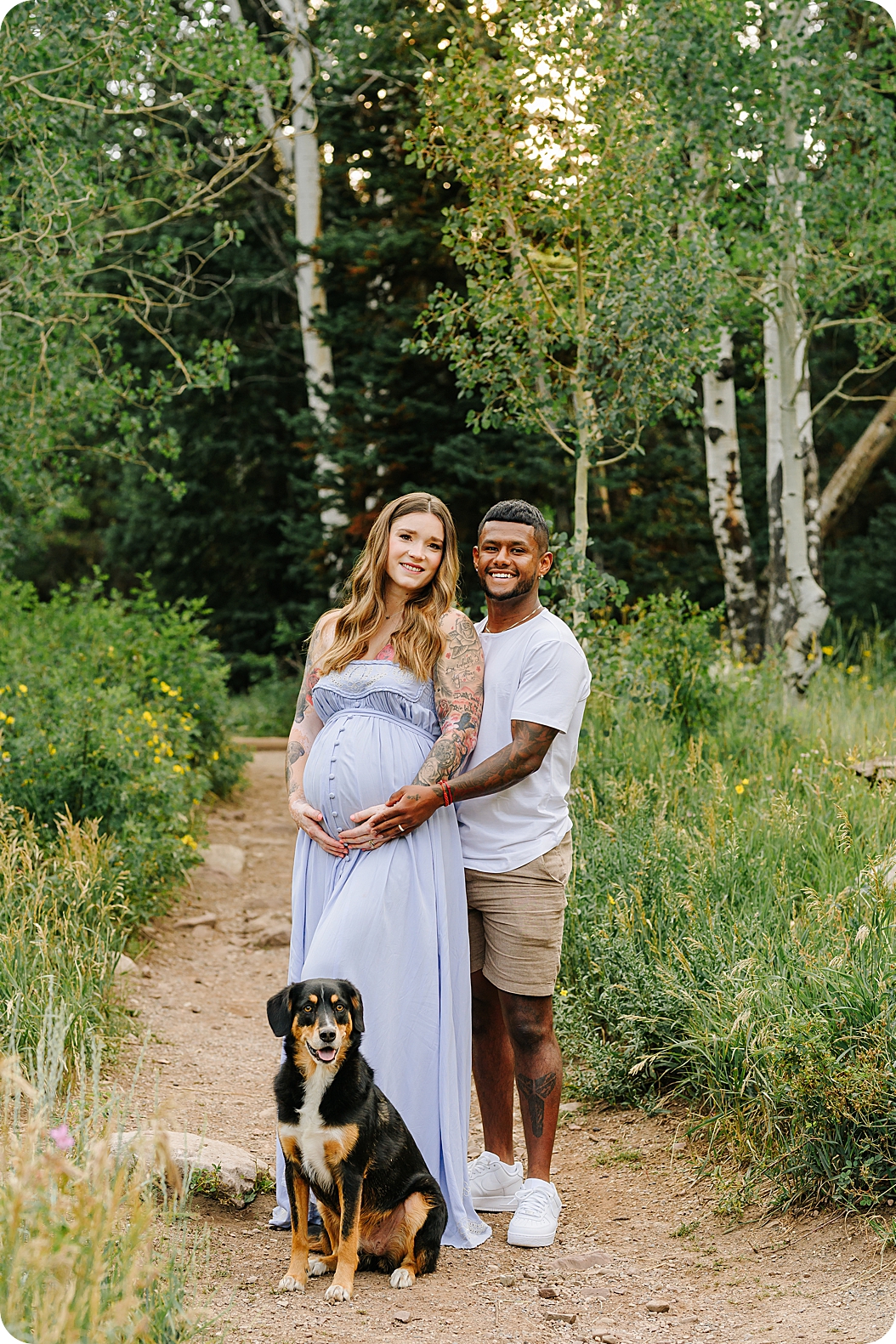 expecting parents pose with dog during canyon maternity portraits at sunrise 