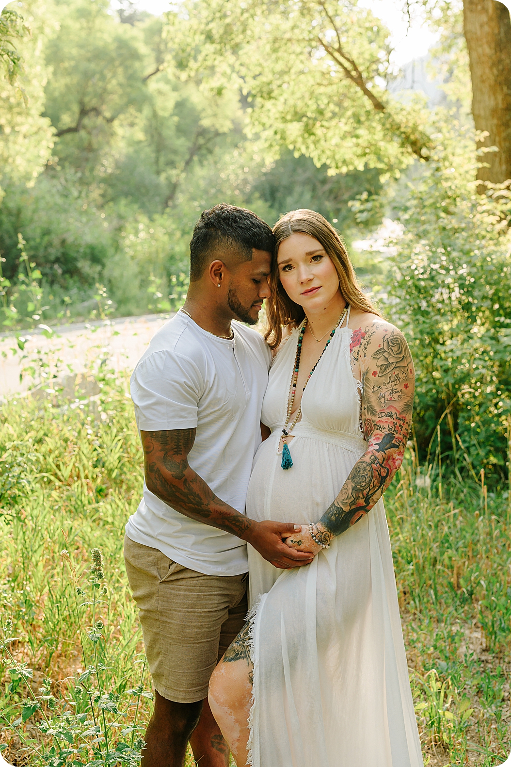 couple stands together during canyon maternity portraits