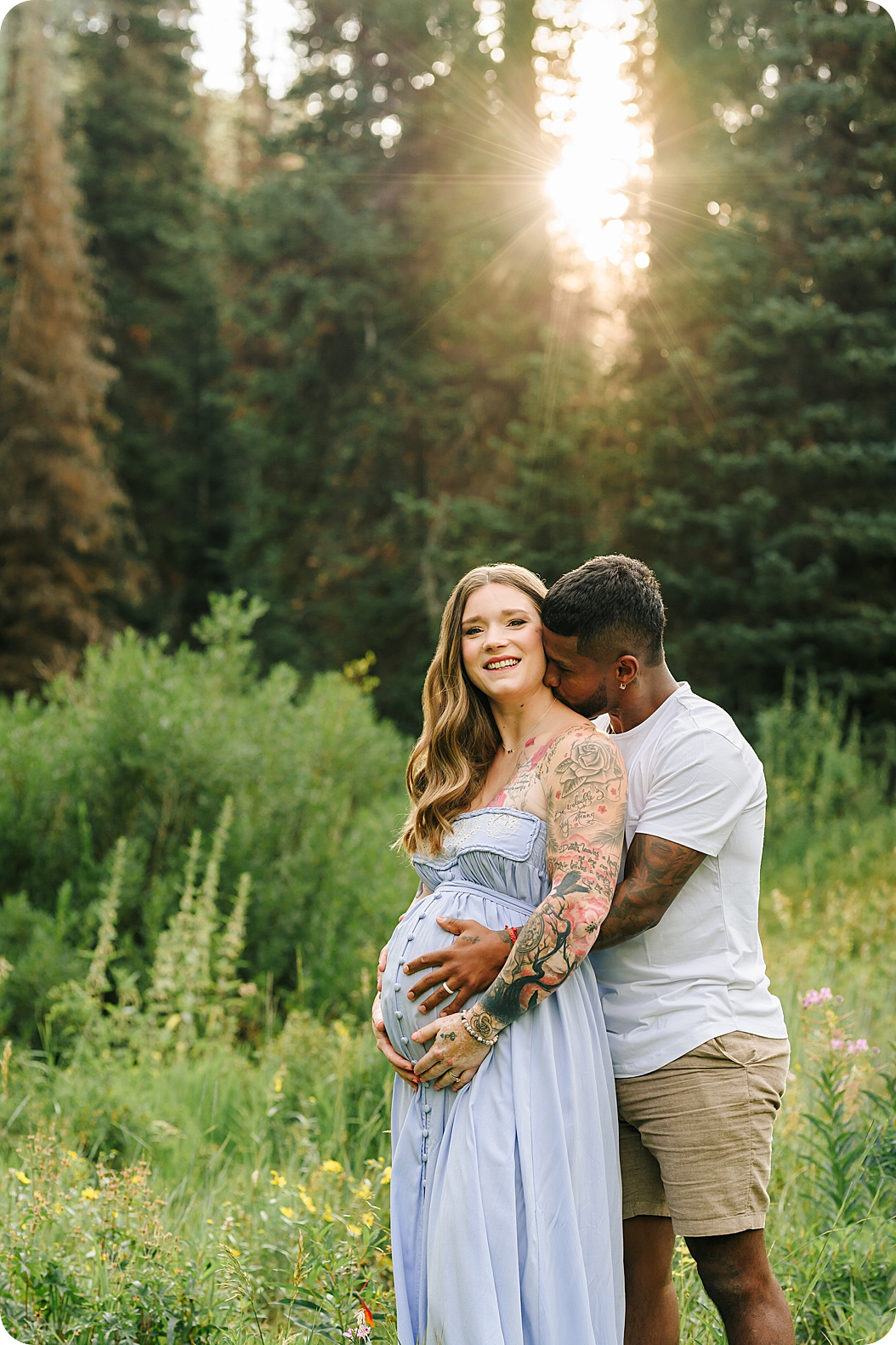 man hugs wife during maternity session in Utah 
