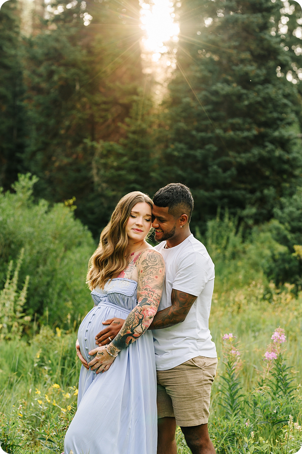 dad hugs mom and holds belly during maternity session in Utah