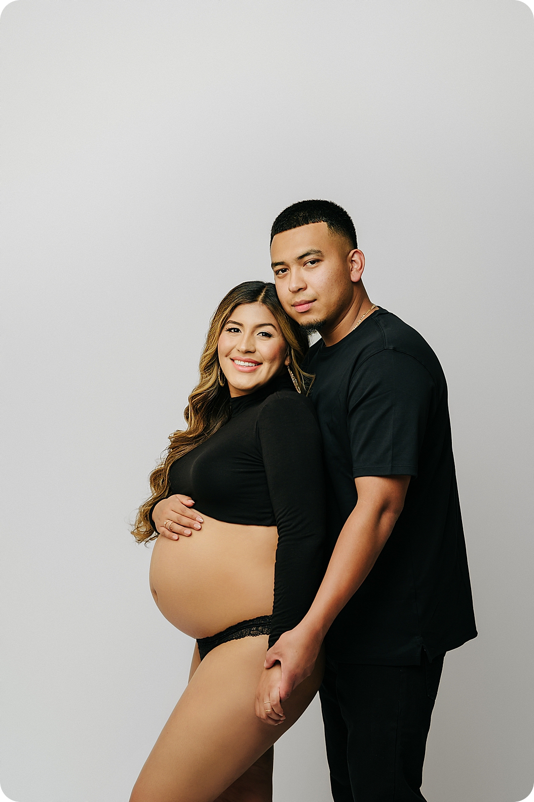 couple poses in studio during fashion inspired maternity session