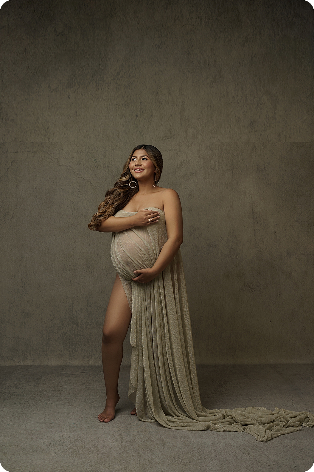 woman poses in Utah studio during fashion inspired maternity session