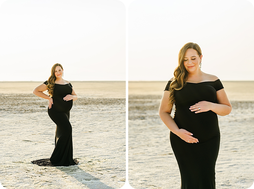 mom in elegant black gown holds belly during sunset maternity portraits on the lake